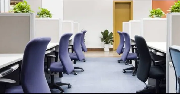 A set of cubicles with chairs inside a new office location in Dubai, by Austria BC