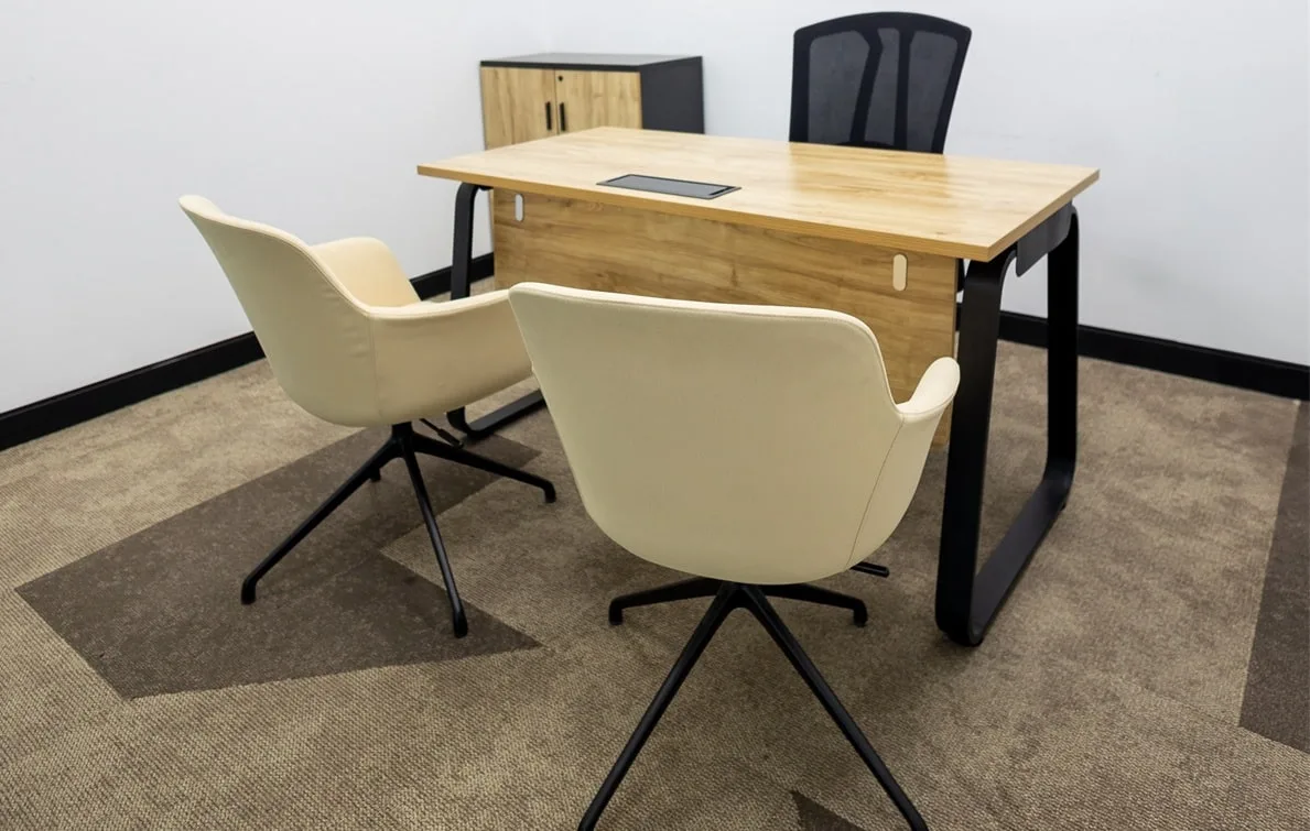 An interior of a private serviced office in Al Hudaiba with chairs and tables, by Austria BC