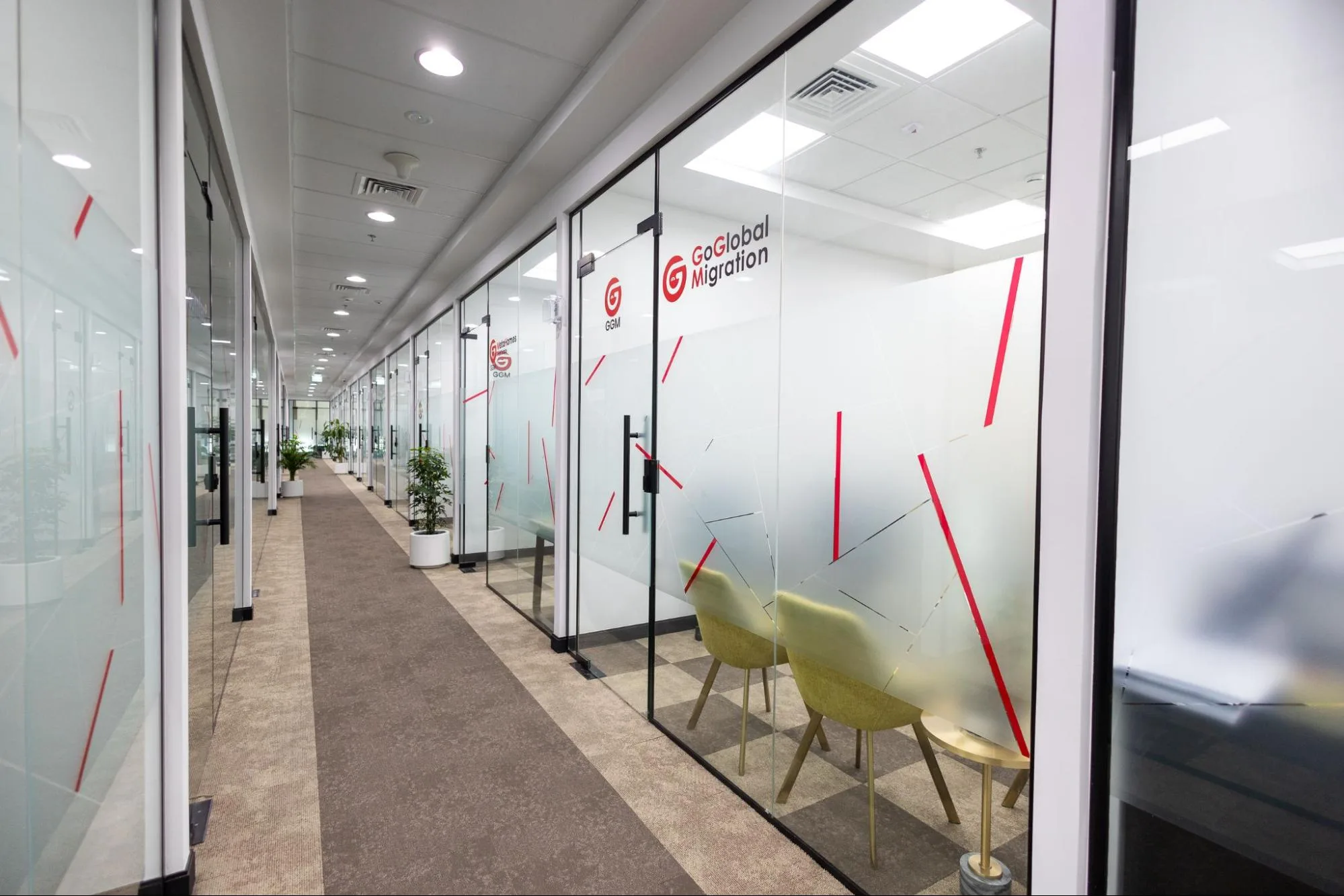 A long virtual office in Dubai hallway with glass-walled rooms at Austria Business Center.