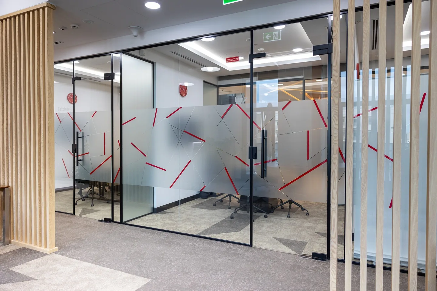 Modern glass-walled meeting rooms at Austria Business Center, providing premium facilities included in virtual office plans in Dubai.
