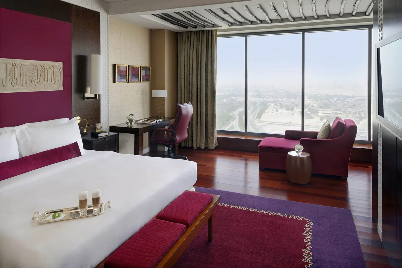 A spacious and luxury room at H Hotel Dubai overlooking the city. 
