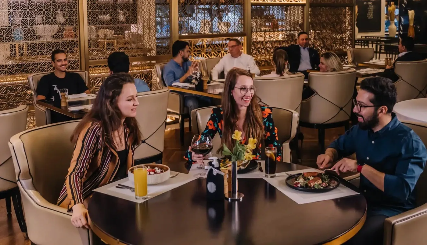 People eating and relaxing at one of the restaurants in H Hotel Dubai.