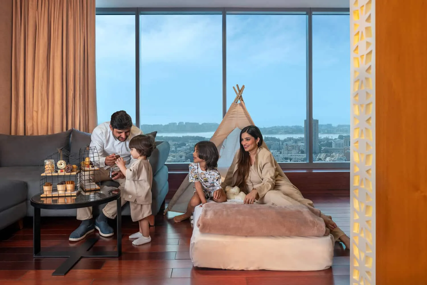 A picture of a family bonding in one of the rooms in H Hotel Dubai. 